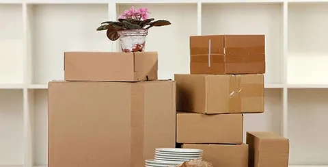 Packed moving boxes in a bright room