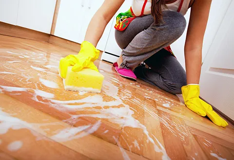Cleaner wiping a kitchen counter